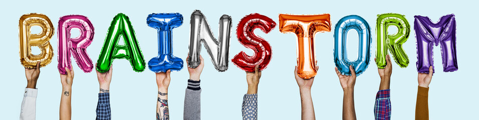 Hands showing brainstorm balloons word