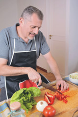 Close up of man cutting vegetables on the board