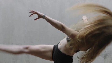 dancing woman talented young caucasian street dancer performing contemporary moves enjoying modern dance expression practicing in grungy warehouse close up