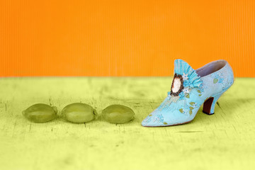Miniature Shoe Beside Squashed Grapes
