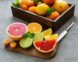 box with citrus fresh fruits on a concrete background