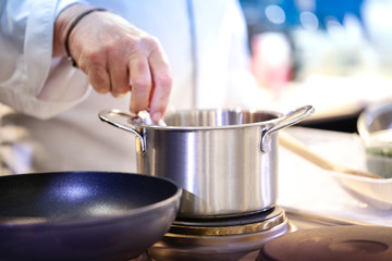 Chef preparing food in the kitchen, chef cooking, closeup, chef at work.
