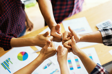 Business people putting Successful good luck thumbs-up hand together.Friends with stack of hands showing unity and teamwork.joining for cooperation and relationship success business,win in every thing