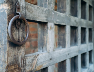 Old wooden gate with a metal ring
