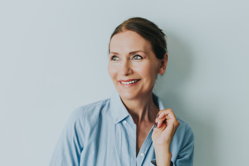Beautiful mature woman smiling.Close up portrait of beautiful older woman smiling and standing by...