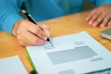 Businessperson Signing Contract about insurance, Two men writing with pen sign of modest agreements form In modern office, morning light, vintage color, success of business partners concept