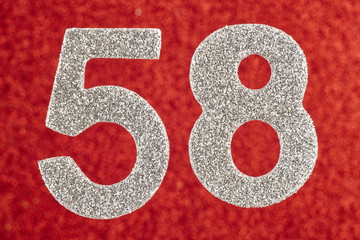 Number fifty-eight silver color over a red background. Anniversary