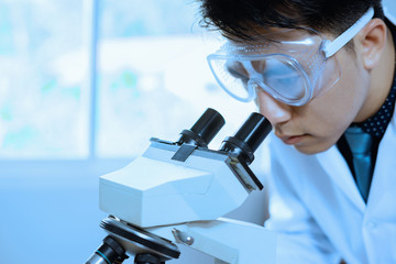 doctor supervisor looking at the microscope slide in the forensic,Laboratory Medical scientists...