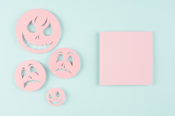 Halloween concept art of cut paper - pink empty square sticker and spooky faces on candy mint blue background.