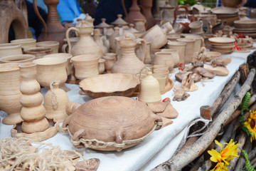 Traditional ceramic jugs on decorative towel. Showcase of handmade ceramic pottery.