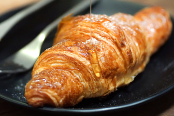croissants with honey on plate close yummy