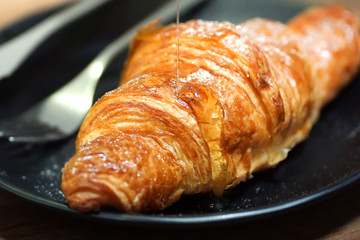 croissants with honey on plate close yummy