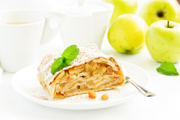 apple strudel with cinnamon and an ice cream ball.
