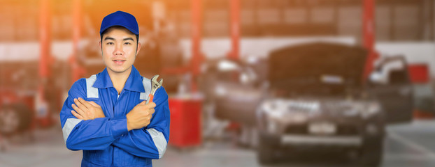 Asian Thai Technician repairing the car in garage,mechanics fixing in a workshop suspension detail...
