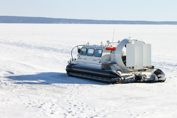 Hovercraft on ice of frozen lake in winter