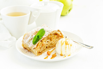 apple strudel with cinnamon and an ice cream ball.