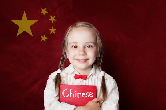 Chinese concept. Little girl student with book against the Chinese flag background. Learn language