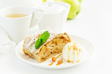 apple strudel with cinnamon and an ice cream ball.