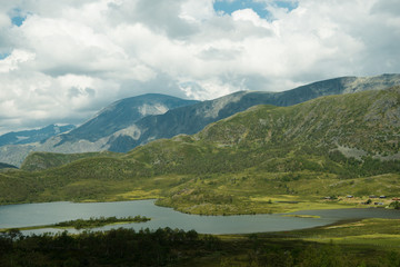 landscape view of river and mountains with overcasted sky, Hallingskarvet National park, Norway