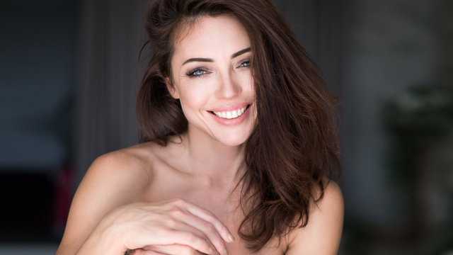 Close-up portrait of an attractive young woman smiling.
