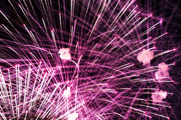Salute in the night sky. Bright texture of festive fireworks. Abstract holiday background with various colors fireworks light. New Year's, Christmas lights in the sky, colorful lights.