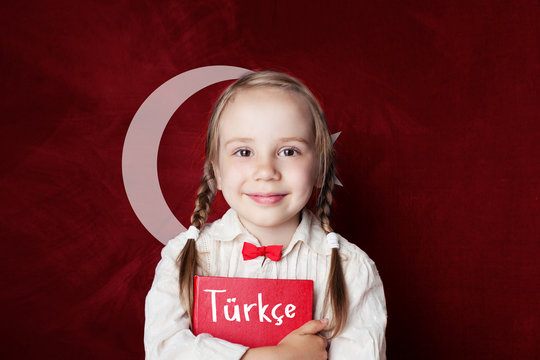 Turkish language concept. Cute child girl student on the Turkey flag background. Learn turkish language