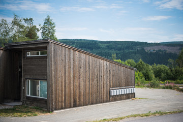 wooden building with green mountain on background, Trysil, Norway's largest ski resort