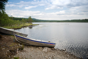 Naklejka na ściany i meble lake with moored wooden boats in Trysil, Norway's largest ski resort