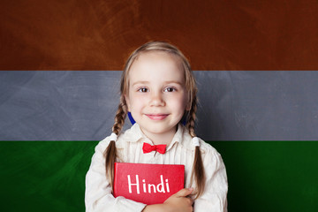 Hindi concept with little girl student against the India flag background. Learn hindi language