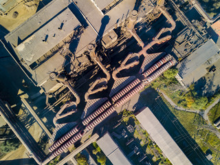 Concept of environmental pollution, drone view of smokestack pipe steel plant, aerial industrial panoramic landscape with blue sky and autumn vegetation, air emissions from manufacturing sector,Russia