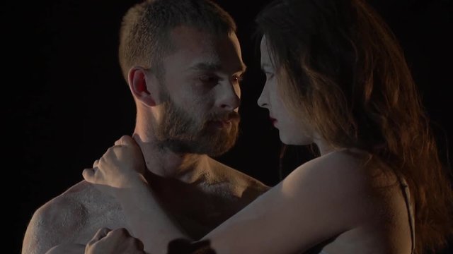 Man hugging woman and looking in love