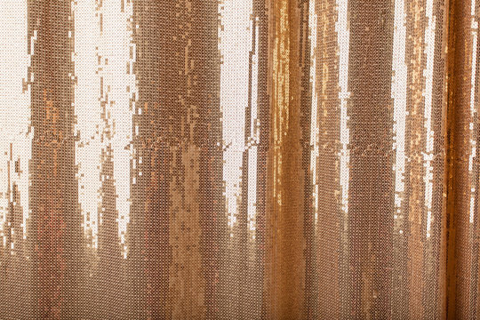 Background of golden bright sparkles on the fabric