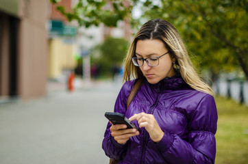 girl on the street looking at the phone