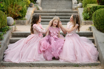 Beautiful girls in amazing dress outdoor. Children bridesmaids