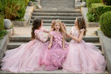 Beautiful girls in amazing dress outdoor. Children bridesmaids