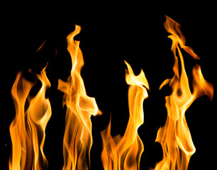 sparks of four yellow bright flames on black