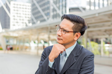 Young Asia handsome businessman thinking about his business