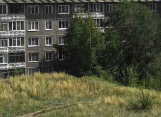 Fototapeta na wymiar Soviet architecture. Ust-Kamenogorsk (Kazakhstan). Apartment building. Soviet architectural style. Typical socialist apartment building. Apartment block