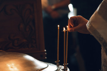 Priest lights candles