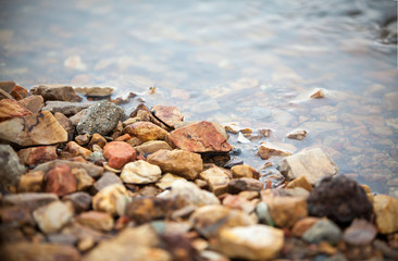 colorful pebble, clear water with gravel at side of the lake, imafe for background,wallpaper, copy space
