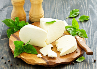 cheese brynza  and garlic on a cutting board.