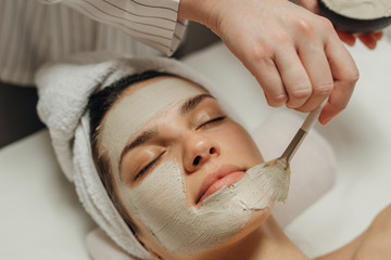 Obraz na płótnie Canvas Cosmeotologist Applying a Facial Mask