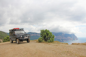 A large jeep on top of a mountain, in nature, in the summer in the Crimea. Extreme travel © Ekaterina