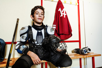 Hockey player preparing for game in locker room