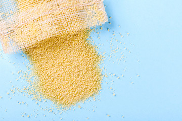 Couscous dry on a blue colored Background.Top View Copy space for Text. Flat Lay.