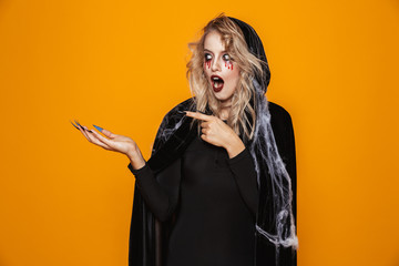 Shoked woman witch pointing at copy space isolated