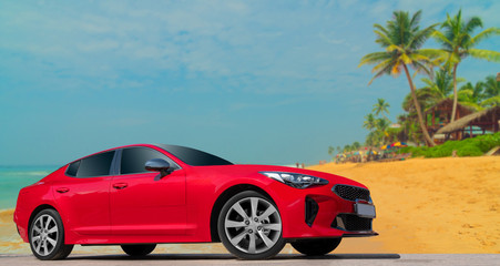 Red car on background of palm trees. Stylish, modern, bright image of car for design solutions.