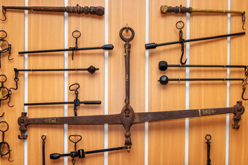 Several old lever steelyards hanging on the wooden wall