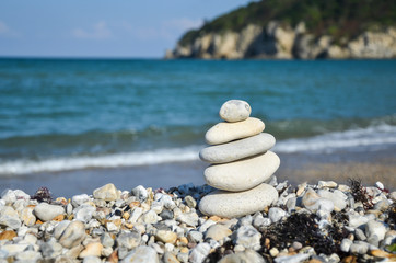 Stack of stones on the  beach in summer.