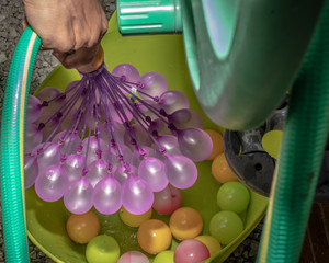 Water balloons being filled up for fun fights in the garden. 